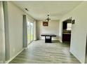 Bright dining area featuring modern flooring and a sliding glass door, seamlessly connecting indoor and outdoor spaces at 5411 Cliff Ridge Dr, Indianapolis, IN 46217