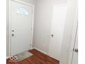 Bright entryway featuring a front door and hardwood floors at 5411 Cliff Ridge Dr, Indianapolis, IN 46217