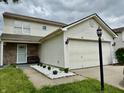 Charming two-story home featuring vinyl siding, a two-car garage, and a well-maintained front yard at 5411 Cliff Ridge Dr, Indianapolis, IN 46217
