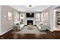 Bright living room with a white fireplace, modern decor, and hardwood floors at 5504 Indianola Ave, Indianapolis, IN 46220