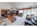 Bright living room with vaulted ceiling, plush seating, and large windows overlooking backyard at 6146 Franklin Villas Way, Indianapolis, IN 46237