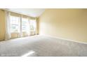 Inviting living room with carpet flooring and lots of natural light from the large window at 6472 Creekshore Ln, Indianapolis, IN 46268