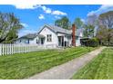 Traditional home with a white picket fence and lush green lawn at 704 Baronne St, Lebanon, IN 46052