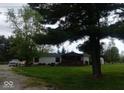 Lovely home with a covered porch and a spacious front yard at 7639 N Frontage Rd, Fairland, IN 46126