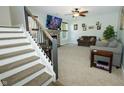 Cozy living room with fireplace, plush carpeting, and stairway to the left at 7926 White Pine Dr, Avon, IN 46123