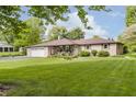 Charming brick ranch-style home with a well-manicured front yard and an attached two-car garage at 807 Whitmore St, Anderson, IN 46012