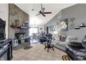 Comfortable living room features a stone fireplace, vaulted ceilings, and ample natural light at 8141 Rob Ln, Indianapolis, IN 46237