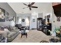 Inviting living room features plush seating, neutral carpet, ceiling fan and large window at 8141 Rob Ln, Indianapolis, IN 46237