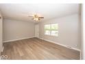 Inviting living room boasts gray walls, wood-look flooring, and a ceiling fan at 8145 Railroad Rd, Indianapolis, IN 46217