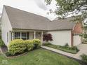 Attractive single-story home with a cozy front porch, tidy landscaping, and a brick-accented garage at 820 Scotch Pine Dr, Greenwood, IN 46143