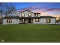 Charming two-story home boasting a lush green lawn and eye-catching black and gold trim at 8315 N Payne Rd, Indianapolis, IN 46268