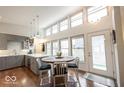 Sun-filled kitchen with a dining area and modern gray cabinets, stainless appliances and hardwood flooring at 949 Harrison St, Indianapolis, IN 46202