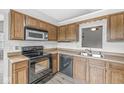 Traditional kitchen featuring wood cabinets, black appliances and laminate countertops at 9553 Maple Way, Indianapolis, IN 46268