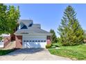 Spacious two-car garage with a white door and well-maintained landscaping at 9602 Sweet Clover Way, Fishers, IN 46038