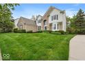 Inviting two-story home with brick and siding, complemented by lush green lawn at 9656 Loganberry Ln, Indianapolis, IN 46256