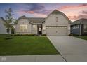Charming single-story home with a well-manicured lawn, neutral brick, and an attached two-car garage at 9696 Parkhurst Xing, McCordsville, IN 46055