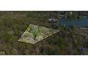 Aerial view of property with tree coverage, highlighting its peaceful setting and location near the water at 9806 Raintree N Dr, Columbus, IN 47201