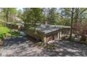 Well-maintained exterior with a spacious driveway and attached garage, surrounded by trees at 9806 Raintree N Dr, Columbus, IN 47201