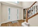 Welcoming foyer with a bright front door, hardwood floors, and staircase at 10746 Gateway Dr, Fishers, IN 46037