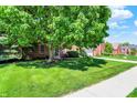 Picture of a home with a large shade tree, green lawn, and a brick facade at 10746 Gateway Dr, Fishers, IN 46037