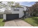 Two-story home featuring a two-car garage, manicured lawn, and cozy front porch at 110 Meadow Creek Blvd, Whiteland, IN 46184