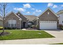 Charming brick home with a well-manicured lawn and inviting front entrance at 1275 Cliff View Dr, Westfield, IN 46074