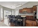 Modern kitchen with a center island, stainless steel appliances, and hardwood floors at 1275 Cliff View Dr, Westfield, IN 46074