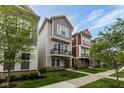 Neighborhood street view showcasing modern homes with inviting front yards and green trees under blue skies at 13323 Susser Way, Fishers, IN 46037