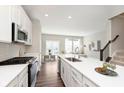 Open kitchen concept featuring stainless appliances and sightlines into dining and living spaces at 13776 Tender Dr, Carmel, IN 46032