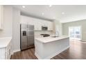 Bright kitchen featuring stainless steel appliances, quartz countertops, and a large island at 13776 Tender Dr, Carmel, IN 46032