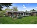 Rear exterior of home featuring a screened-in porch and well-maintained landscaping at 1402 Arcola Ct, Beech Grove, IN 46107