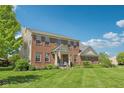 Beautiful two-story brick home on a spacious lot with lush green lawn and mature trees at 14162 Nicholas Dr, Carmel, IN 46074