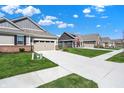 A street view showcasing multiple homes with well-maintained lawns and sidewalks in a friendly neighborhood setting at 15004 Stonneger St, Westfield, IN 46074