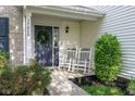 Charming front entrance with a wreath on the door and rocking chairs at 17060 Kingsbridge Blvd, Westfield, IN 46074