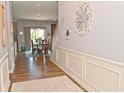 Inviting entryway with hardwood floors, decorative wall art, and a view of the dining room with sliding glass doors at 2075 Longford Ln, Avon, IN 46123