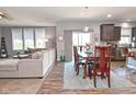 Open-concept living room flows into dining area with sliding glass doors and views of a well equipped kitchen at 2075 Longford Ln, Avon, IN 46123