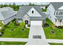 Aerial view of a home with a two-car garage, landscaped yard, and contemporary architecture at 2250 Somerset Dr, Franklin, IN 46131