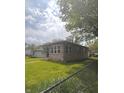 Well maintained single story home with brick facade and green lawn at 2402 S Rybolt Ave, Indianapolis, IN 46241
