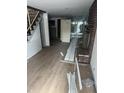 Spacious living room with hardwood floors, a brick fireplace and view to the rear of the home at 2425 S Lyons Ave, Indianapolis, IN 46241