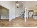Spacious foyer with hardwood floors, high ceilings, staircase, and modern light fixture at 2979 Kings Ct, Carmel, IN 46032
