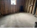 An unfinished room in need of renovation showcases raw framing and plywood subflooring, awaiting transformation at 438 N Keystone Ave, Indianapolis, IN 46201
