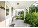 View of the covered front porch with outdoor seating and a view of the front yard at 4406 Carrollton Ave, Indianapolis, IN 46205
