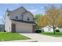 Charming home with a well-maintained lawn, spacious driveway, attached garage, and mature tree in the yard at 4625 Elkhorn Ct, Noblesville, IN 46062