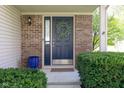 Inviting entryway featuring a blue front door with a decorative wreath and manicured green bushes at 4625 Elkhorn Ct, Noblesville, IN 46062