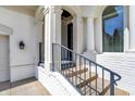 A close-up of the front porch showcasing white pillars, metal railings, and stone stairs leading to the entrance at 4726 Ellery Ln, Indianapolis, IN 46250