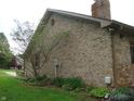 Side view of the brick home showing the exterior architecture and landscaping at 4806 Krestridge E Ct, Bargersville, IN 46106