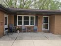 Inviting front porch with seating area, windows, and a storm door, perfect for relaxing at 5107 Saddle Ln, Anderson, IN 46013