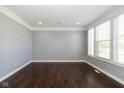 Neutral room with gray walls, white trim, hardwood floors and bright natural light at 5141 S Cobblestone Dr, Zionsville, IN 46077