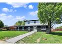 Beautiful two-story home with a well-manicured lawn and a stone walkway leading to the front door at 5354 Brendon Park Dr, Indianapolis, IN 46226