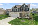 Charming two-story home with a well-manicured lawn, two car garage, and inviting front porch at 5363 Citadel Dr, Noblesville, IN 46062